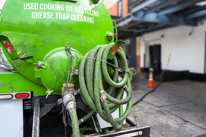 grease trap being pumped out by service technician in Biggs CA